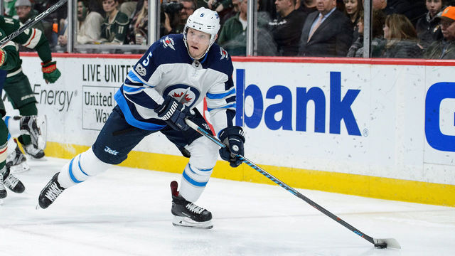 ST PAUL, MN - OCTOBER 31: Dmitry Kulikov #5 of the Winnipeg Jets controls the puck against the Minnesota Wild during the game on October 31, 2017 at Xcel Energy Center in St Paul, Minnesota. The Jets defeated the Wild 2-1.