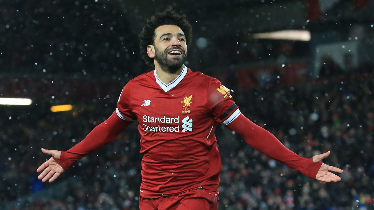 Liverpool's Egyptian midfielder Mohamed Salah celebrates scoring the team's fourth goal during the English Premier League football match between Liverpool and Watford at Anfield in Liverpool, north west England on March 17, 2018. / AFP PHOTO / Lindsey PARNABY /