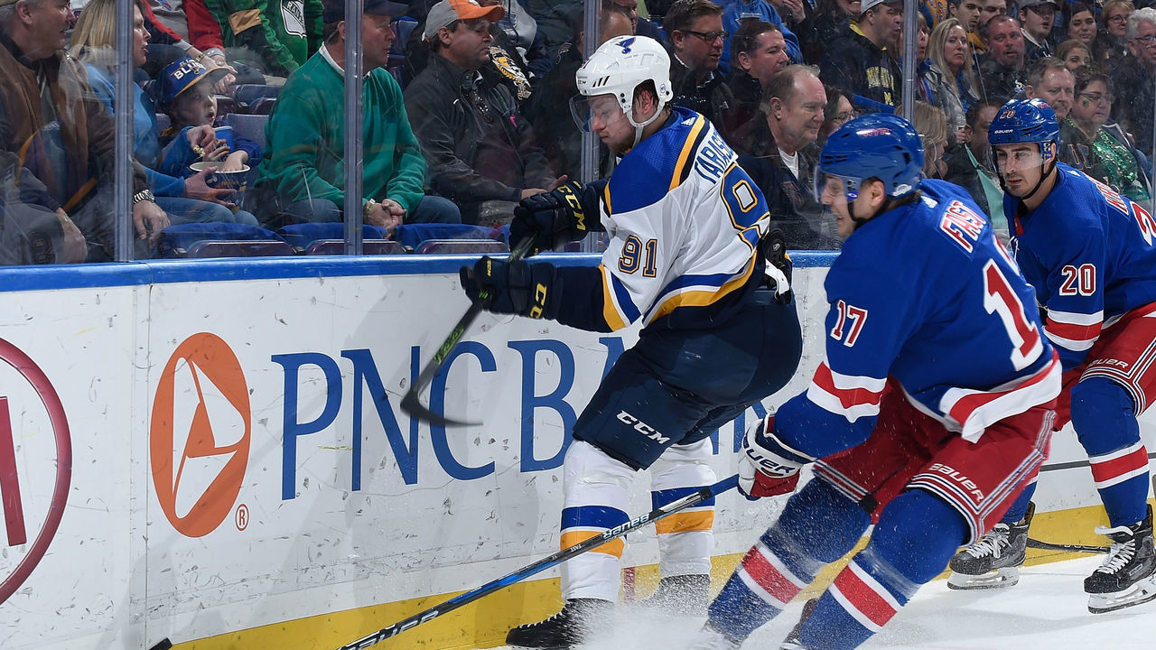 ST. LOUIS, MO - MARCH 17: Vladimir Tarasenko #91 of the St. Louis Blues and Jesper Fast #17 of the New York Rangers battle for the puck at Scottrade Center on March 17, 2018 in St. Louis, Missouri.