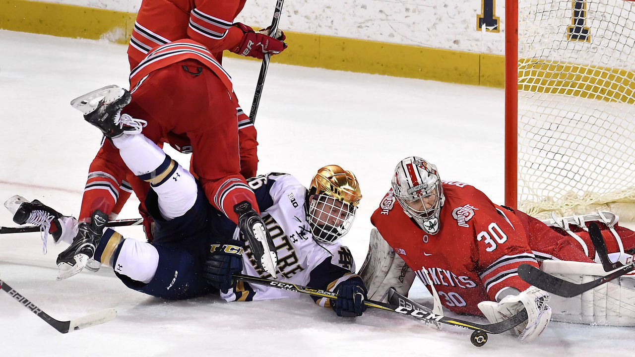 SOUTH BEND, IN - FEBRUARY 10: Ohio State Buckeyes goaltender Sean Romeo (30) makes a save on the shot from Notre Dame Fighting Irish forward Cam Morrison (26) during the game between the Notre Dame Fighting Irish and the Ohio State Buckeyes on February 10, 2018 at the Compton Family Ice Arena in South Bend, Indiana.