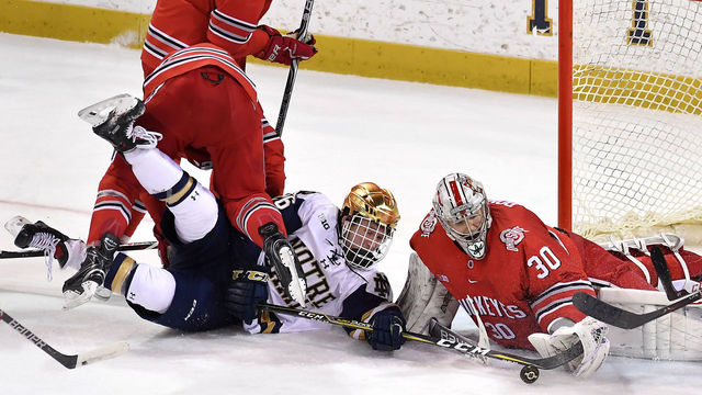 SOUTH BEND, IN - FEBRUARY 10: Ohio State Buckeyes goaltender Sean Romeo (30) makes a save on the shot from Notre Dame Fighting Irish forward Cam Morrison (26) during the game between the Notre Dame Fighting Irish and the Ohio State Buckeyes on February 10, 2018 at the Compton Family Ice Arena in South Bend, Indiana.