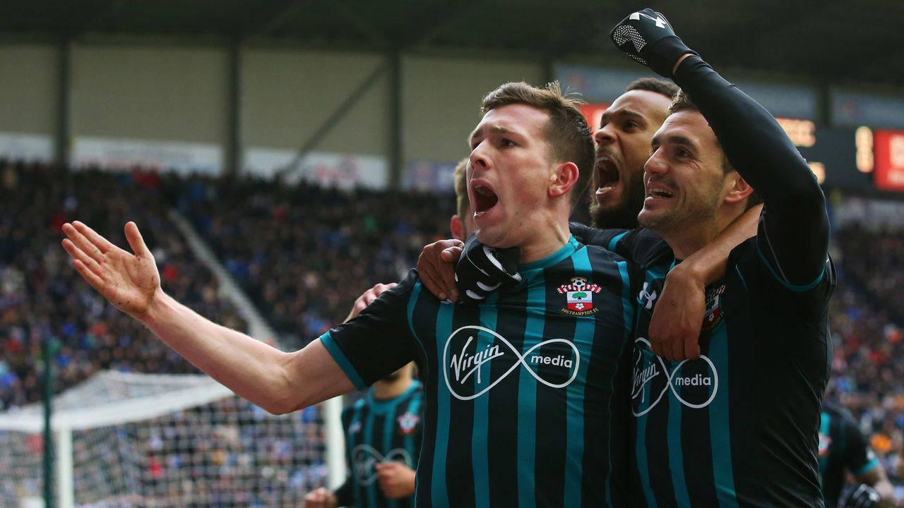 WIGAN, ENGLAND - MARCH 18: Pierre-Emile Hojbjerg of Southampton (L) celebrates as he scores their first goal with Dusan Tadic and Ryan Bertrand during The Emirates FA Cup Quarter Final match between Wigan Athletic and Southampton at DW Stadium on March 18, 2018 in Wigan, England.