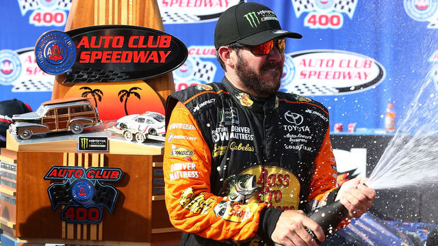 FONTANA, CA - MARCH 18: Martin Truex Jr., driver of the #78 Bass Pro Shops/5-hour ENERGY Toyota, celebrates in victory lane after winning the Monster Energy NASCAR Cup Series Auto Club 400 at Auto Club Speedway on March 18, 2018 in Fontana, California.