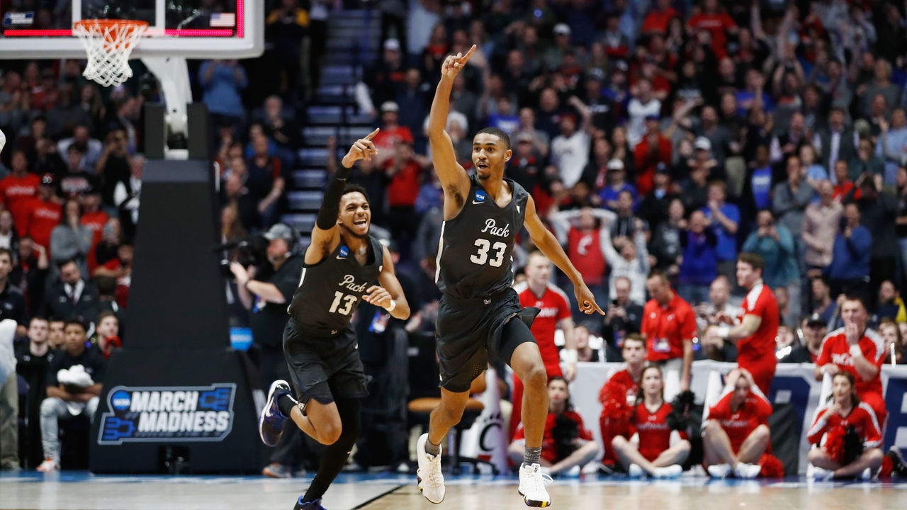 NASHVILLE, TN - MARCH 18: Josh Hall #33 of the Nevada Wolf Pack celebrates with Hallice Cooke #13 after defeating the Cincinnati Bearcats during the second half in the second round of the 2018 Men's NCAA Basketball Tournament at Bridgestone Arena on March 18, 2018 in Nashville, Tennessee.