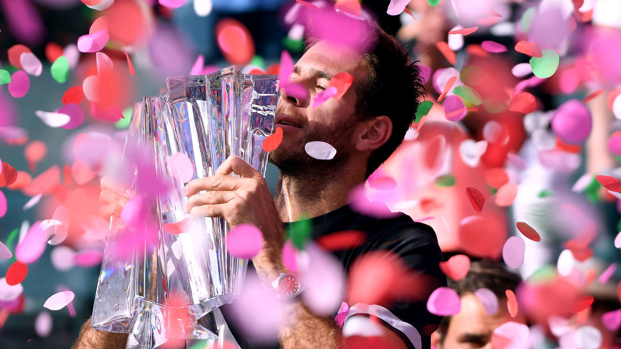 INDIAN WELLS, CA - MARCH 18: Juan Martin Del Potro of Argentina holds up the trophy in front of Roger Federer of Switzerland after his victory in the ATP final during the BNP Paribas Open at the Indian Wells Tennis Garden on March 18, 2018 in Indian Wells, California.