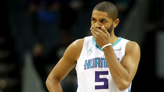 CHARLOTTE, NC - MARCH 06: Teammates Nicolas Batum #5 and Kemba Walker #15 of the Charlotte Hornets watch on against the Philadelphia 76ers during their game at Spectrum Center on March 6, 2018 in Charlotte, North Carolina.