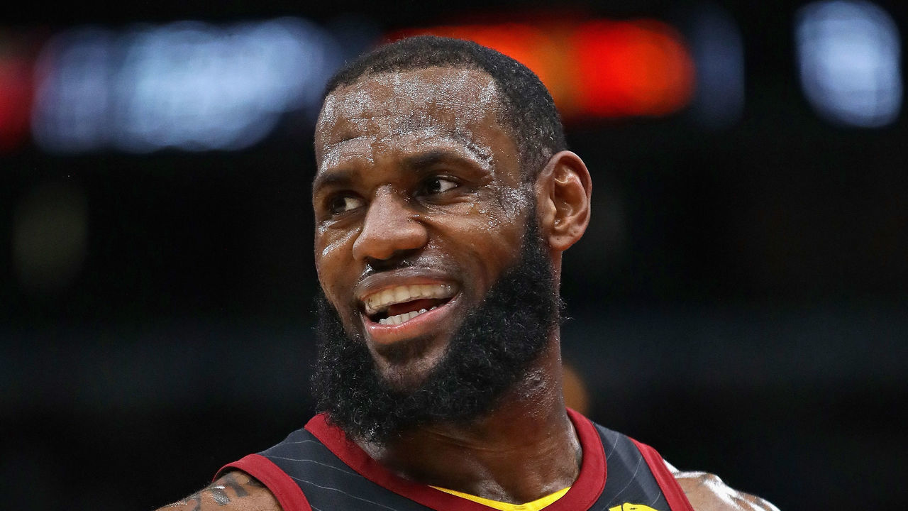 CHICAGO, IL - MARCH 17: LeBron James #23 of the Cleveland Cavaliers smiles as he talks to teammates on the bench during a game against the Chicago Bulls at the United Center on March 17, 2018 in Chicago, Illinois.