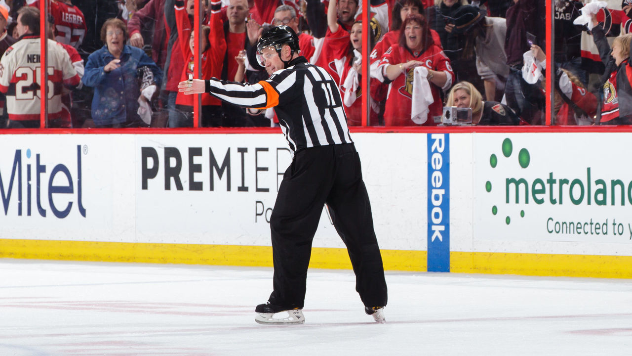 OTTAWA, ON - MAY 6: Referee Kelly Sutherland #11 signals an overtime goal by Kyle Turris #7 (not shown) of the Ottawa Senators against the New York Rangers after a video review for an offside in Game Five of the Eastern Conference Second Round during the 2017 NHL Stanley Cup Playoffs at Canadian Tire Centre on May 6, 2017 in Ottawa, Ontario, Canada.