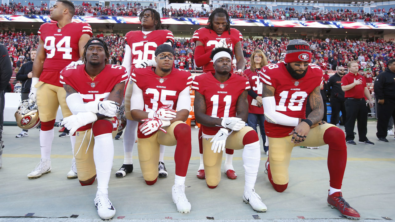 SANTA CLARA, CA - DECEMBER 17: Eli Harold #57, Eric Reid #35, Marquise Goodwin #11 and Louis Murphy #18 of the San Francisco 49ers kneel on the sideline during the anthem as Solomon Thomas #94, Reuben Foster #56 and Adrian Colbert #38 stand with them in support, prior to the game against the Tennessee Titans at Levi's Stadium on December 17, 2017 in Santa Clara, California. The 49ers defeated the Titans 25-23.