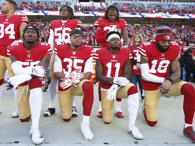 SANTA CLARA, CA - DECEMBER 17: Eli Harold #57, Eric Reid #35, Marquise Goodwin #11 and Louis Murphy #18 of the San Francisco 49ers kneel on the sideline during the anthem as Solomon Thomas #94, Reuben Foster #56 and Adrian Colbert #38 stand with them in support, prior to the game against the Tennessee Titans at Levi's Stadium on December 17, 2017 in Santa Clara, California. The 49ers defeated the Titans 25-23.