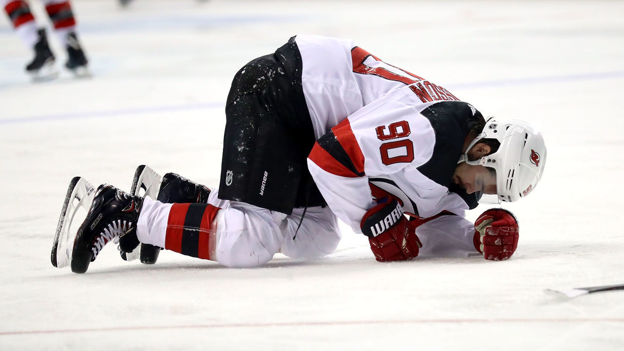 NEW YORK, NY - JANUARY 16: Marcus Johansson #90 of the New Jersey Devils slumps to the ice in the second period after getting injured against the New York Islanders during their game at Barclays Center on January 16, 2018 in the Brooklyn borough of New York City.