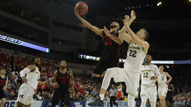 WICHITA, KS - MARCH 17: Galen Robinson Jr. #25 of the Houston Cougars shoots against Duncan Robinson #22 of the Michigan Wolverines in the first half during the second round of the 2018 NCAA Men's Basketball Tournament at INTRUST Bank Arena on March 17, 2018 in Wichita, Kansas.