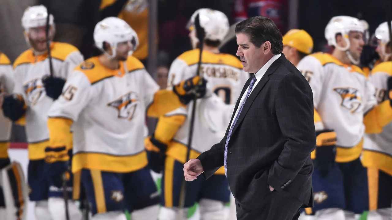 MONTREAL, QC - FEBRUARY 10: Head coach of the the Nashville Predators Peter Laviolette walks past his team as they celebrate their victory against the Montreal Canadiens during the NHL game at the Bell Centre on February 10, 2018 in Montreal, Quebec, Canada. The Nashville Predators defeated the Montreal Canadiens 3-2 in a shootout.