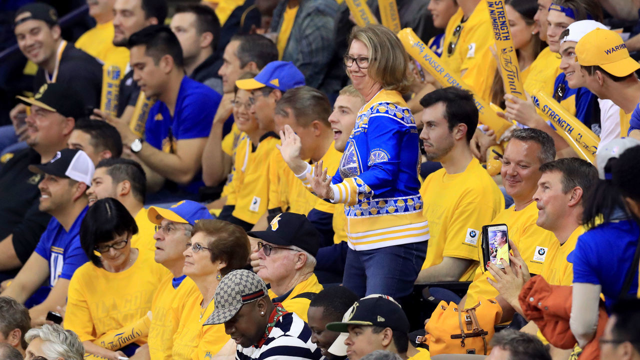 OAKLAND, CA - JUNE 12: A Golden State Warriors fan cheers on her team against the Cleveland Cavaliers in Game 5 of the 2017 NBA Finals at ORACLE Arena on June 12, 2017 in Oakland, California.