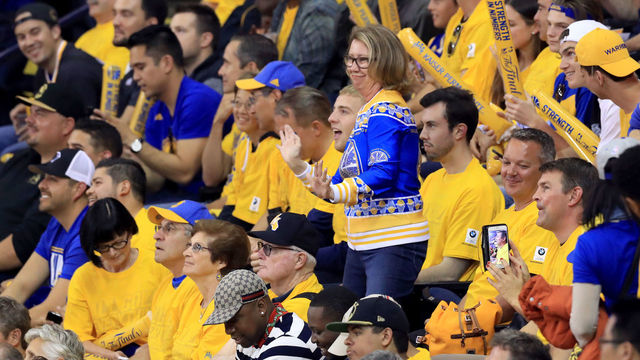OAKLAND, CA - JUNE 12: A Golden State Warriors fan cheers on her team against the Cleveland Cavaliers in Game 5 of the 2017 NBA Finals at ORACLE Arena on June 12, 2017 in Oakland, California.