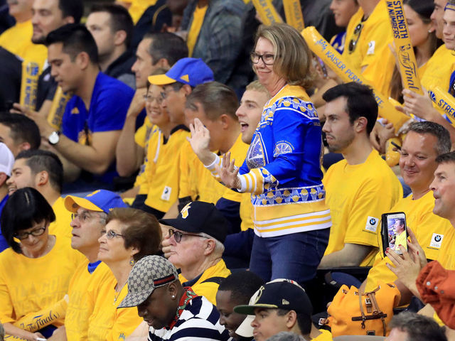 OAKLAND, CA - JUNE 12: A Golden State Warriors fan cheers on her team against the Cleveland Cavaliers in Game 5 of the 2017 NBA Finals at ORACLE Arena on June 12, 2017 in Oakland, California.