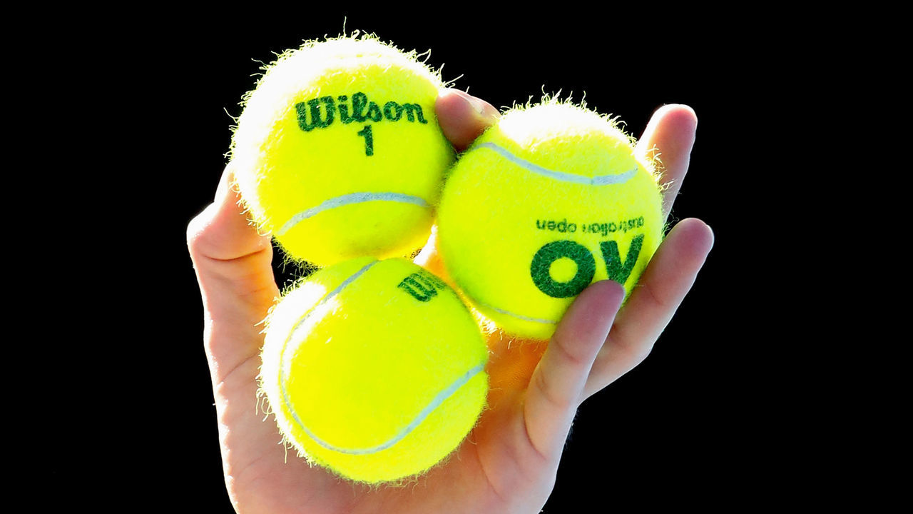 MELBOURNE, AUSTRALIA - JANUARY 22: Marton Fucsovics of Hungary holds tennis balls as he serves in his fourth round match against Roger Federer of Switzerland on day eight of the 2018 Australian Open at Melbourne Park on January 22, 2018 in Melbourne, Australia.