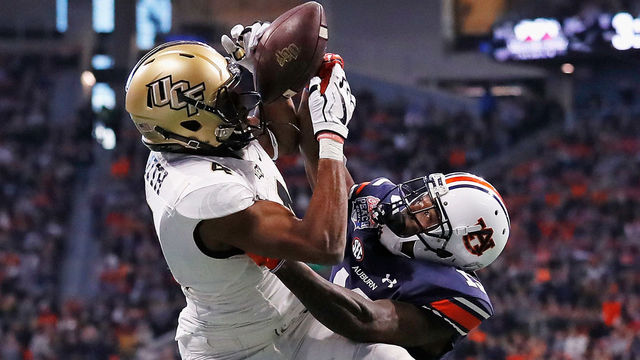 ATLANTA, GA - JANUARY 01: Tre'Quan Smith #4 of the UCF Knights is unable to make a reception against Javaris Davis #13 of the Auburn Tigers in the second half during the Chick-fil-A Peach Bowl at Mercedes-Benz Stadium on January 1, 2018 in Atlanta, Georgia.