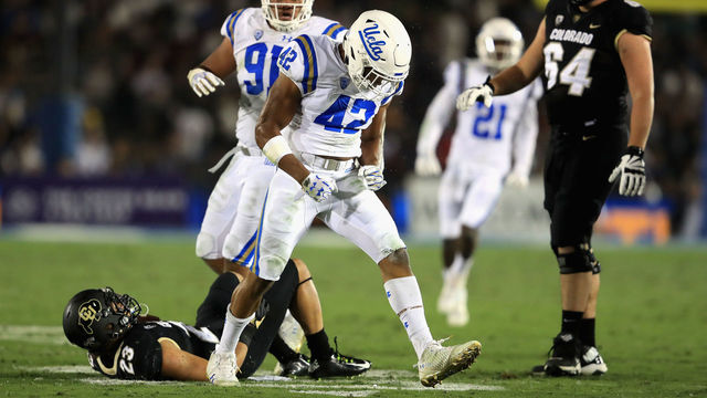 PASADENA, CA - SEPTEMBER 30: Kenny Young #42 and Jacob Tuioti-Mariner #91 of the UCLA Bruins celebrate a tackle of Phillip Lindsay #23 of the Colorado Buffaloes during the first half of a game at the Rose Bowl on September 30, 2017 in Pasadena, California.