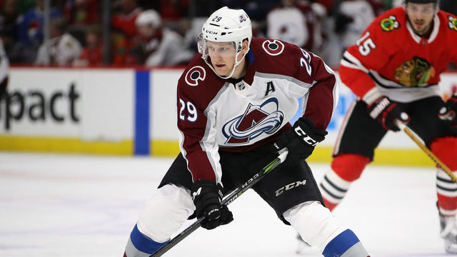 CHICAGO, IL - MARCH 06: Nathan MacKinnon #29 of the Colorado Avalanche advances the puck against the Chicago Blackhawks at the United Center on March 6, 2018 in Chicago, Illinois.