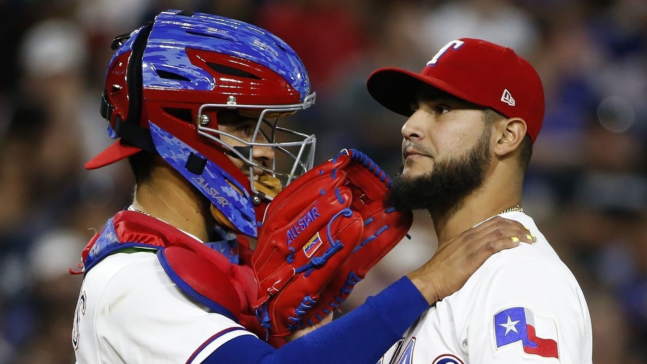 ARLINGTON, TX - SEPTEMBER 8: Robinson Chirinos #61 and Martin Perez #33 of the Texas Rangers talk on the mound as the Rangers play the New York Yankees during the fourth inning at Globe Life Park in Arlington on September 8, 2017 in Arlington, Texas.