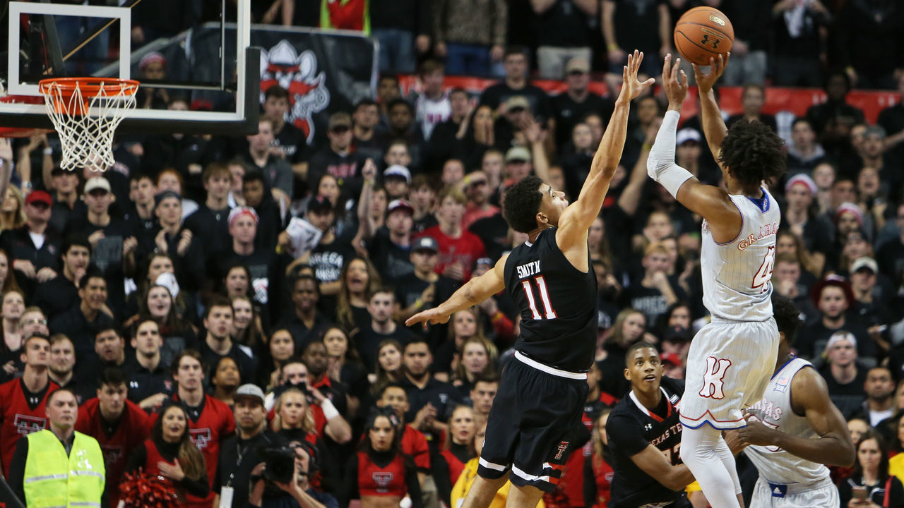 LUBBOCK, TX - FEBRUARY 24: Kansas guard Devonte' Graham (4) takes a three during the No.6 Texas Tech Raider's 74-72 loss to the No.8 Kansas Jayhawks on February 24, 2018 at United Supermarkets Arena in Lubbock, TX.