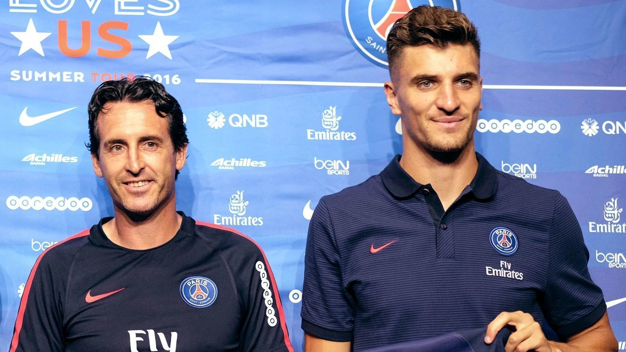 Paris Saint-Germain midfielder Grzegorz Hrychowiak, (L), defender Thomas Meunier (R), and coach Unai Emery pose with their jerseys after a press conference before their International Champions Cup (ICC) game against Leicester City F.C., at StubHub Center in Carson, California on July 29, 2016. The two teams will meet at StubHub Center on July 30, 2016. / AFP PHOTO / RINGO CHIU / The erroneous mention appearing in the metadata of this photo by RINGO CHIU has been modified in AFP systems in the following manner: [Thomas Meunier] instead of [Thomas Meaner]. Please immediately remove the erroneous mention from all your online services and delete it from your servers. If you have been authorized by AFP to distribute it to third parties, please ensure that the same actions are carried out by them. Failure to promptly comply with these instructions will entail liability on your part for any continued or post notification usage. Therefore we thank you very much for all your attention and prompt action. We are sorry for the inconvenience this notification may cause and remain at your disposal for any further information you may require.