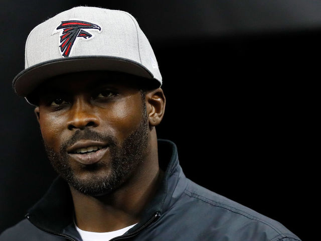 ATLANTA, GA - JANUARY 01: Former Atlanta Falcons player Michael Vick walks on the field prior to the game against the New Orleans Saints at the Georgia Dome on January 1, 2017 in Atlanta, Georgia.
