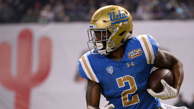 PHOENIX, AZ - DECEMBER 26: Wide receiver Jordan Lasley #2 of the UCLA Bruins runs the football 52 yards to score a touchdown against the Kansas State Wildcats in the first half of the Cactus Bowl at Chase Field on December 26, 2017 in Phoenix, Arizona.