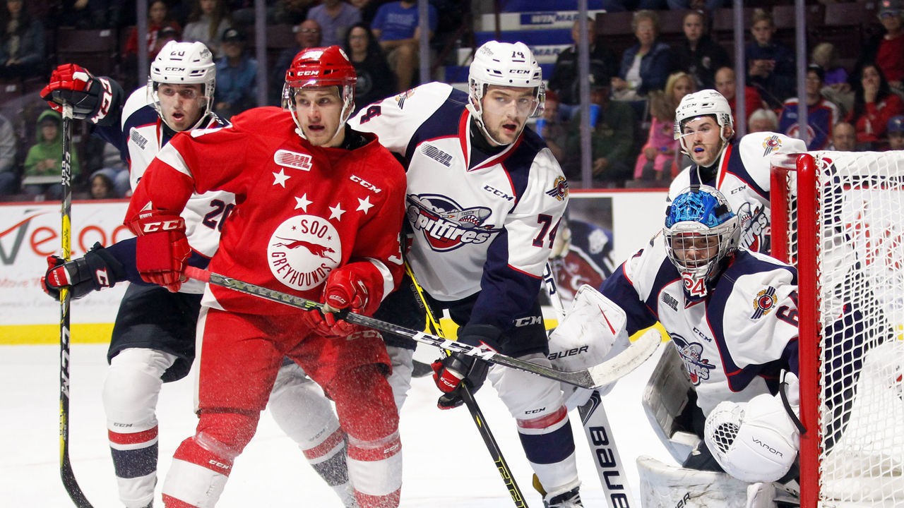 WINDSOR, ON - OCTOBER 05: Forward Hayden Verbeek #38 of the Sault Ste. Marie Greyhounds battles in front of the net against defenceman Sean Day #74 and Michael DiPietro #64 of the Windsor Spitfires on October 5, 2017 at the WFCU Centre in Windsor, Ontario, Canada.