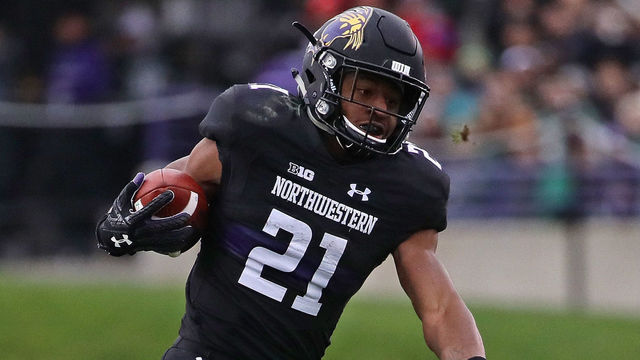 EVANSTON, IL - OCTOBER 28: Justin Jackson #21 of the Northwestern Wildcats breaks a tackle by Joe Bachie #35 of the Michigan State Spartans at Ryan Field on October 28, 2017 in Evanston, Illinois.