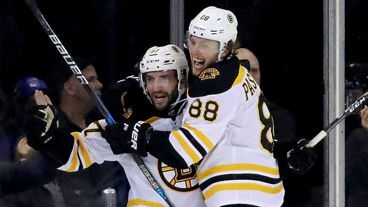 NEW YORK, NY - FEBRUARY 07: Patrice Bergeron #37 and David Pastrnak #88 of the Boston Bruins celebrate after Bergeron's goal put the Bruins up 3-1 against the New York Rangers in the second period at Madison Square Garden on February 7, 2018 in New York City.