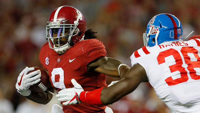 TUSCALOOSA, AL - SEPTEMBER 30: Bo Scarbrough #9 of the Alabama Crimson Tide rushes away from Marquis Haynes #38 of the Mississippi Rebels at Bryant-Denny Stadium on September 30, 2017 in Tuscaloosa, Alabama.