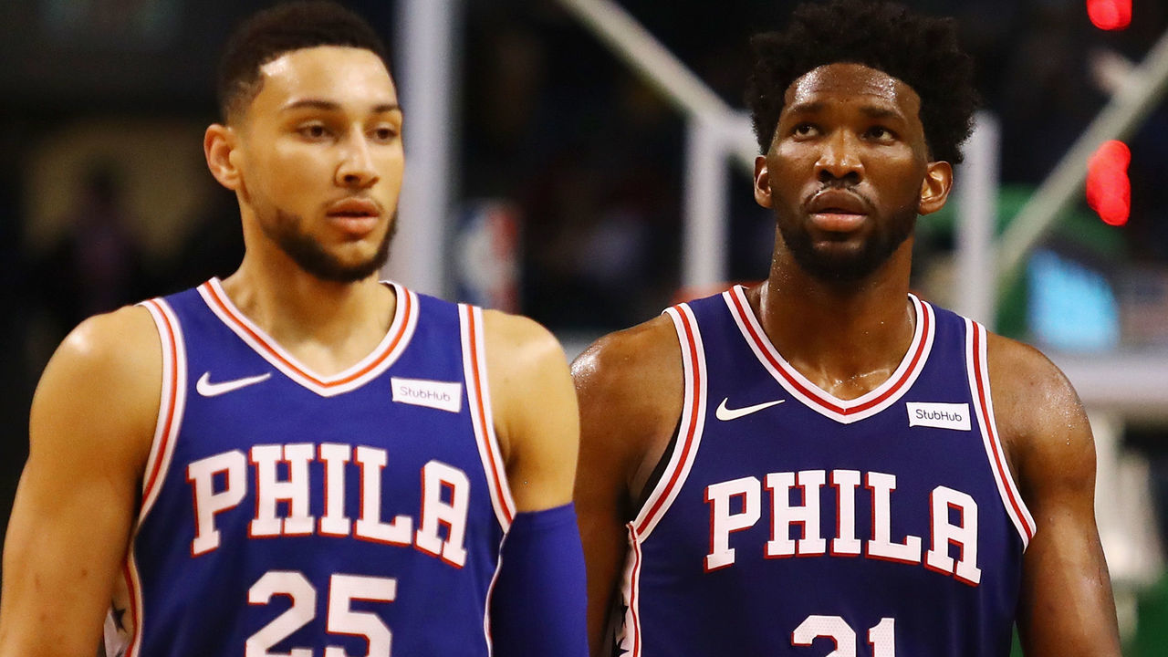 BOSTON, MA - JANUARY 18: Ben Simmons #25 and Joel Embiid #21 of the Philadelphia 76ers walk off the court during a time out in the second half against the Boston Celtics at TD Garden on January 18, 2018 in Boston, Massachusetts.