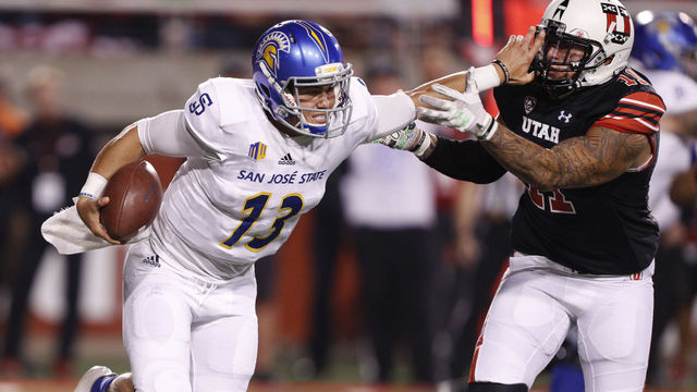 SALT LAKE CITY, UT - SEPTEMBER 16: Quarterback Sam Allen #13 of the San Jose State Spartans, stiff arms defensive end Kylie Fitts #11 of the Utah Utes, during the first of an college football game September 16, 2017 at Rice Eccles Stadium in Salt Lake City, Utah.