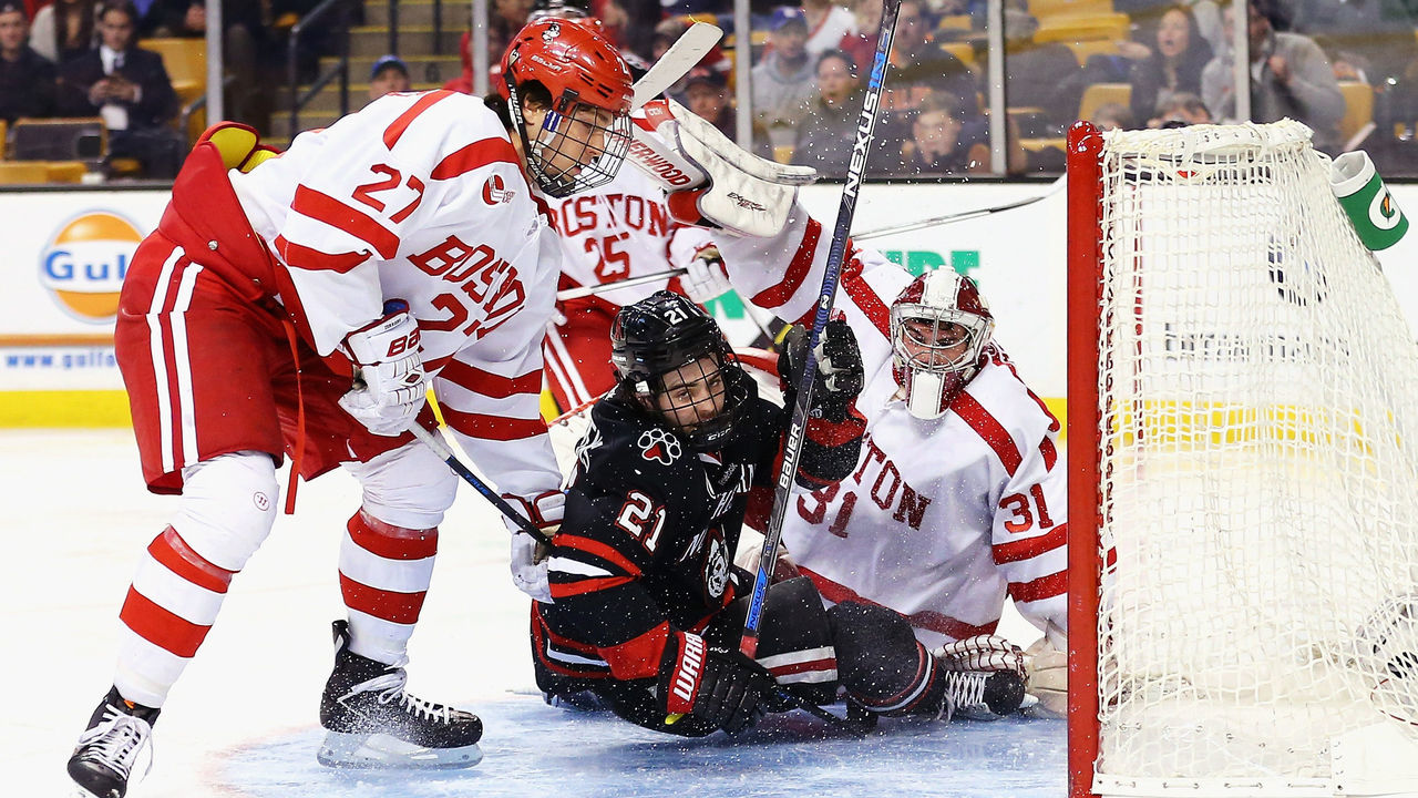 BOSTON, MA - FEBRUARY 01: Nolan Stevens #21 of the Northeastern Huskies collides with Sean Maguire #31 of the Boston University Terriers in the goal during the second period at TD Garden on February 1, 2016 in Boston, Massachusetts.