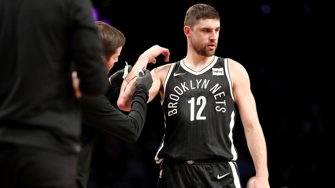 NEW YORK, NY - MARCH 21: Joe Harris #12 of the Brooklyn Nets is attended to by trainers after being injured in the fourth quarter against the Charlotte Hornets during their game at Barclays Center on March 21, 2018 in the Brooklyn borough of New York City.