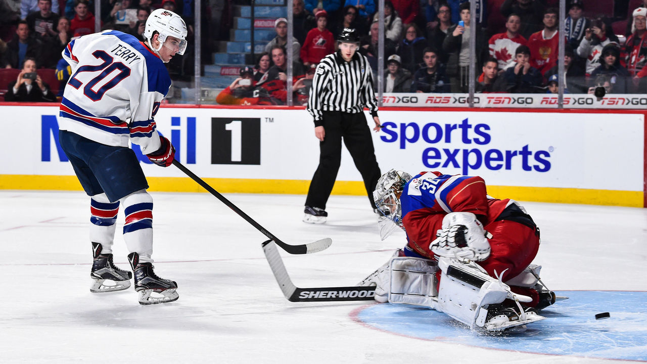 MONTREAL, QC - JANUARY 04: Troy Terry #20 of Team United States gets the puck past goaltender Ilya Samsonov #30 of Team Russia in a shootout to score the game winning goal during the 2017 IIHF World Junior Championship semifinal game against Team Russia at the Bell Centre on January 4, 2017 in Montreal, Quebec, Canada. The Team United States defeated Team Russia 4-3 in a shootout.