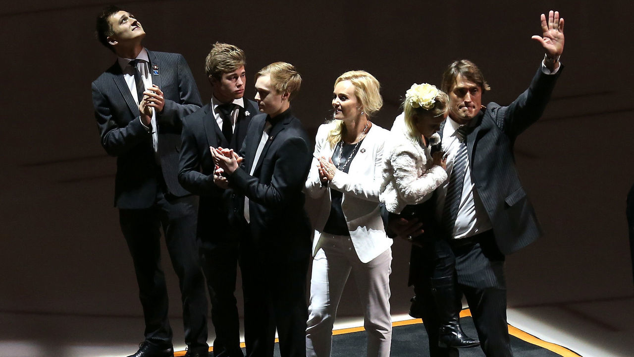 ANAHEIM, CA - JANUARY 11: Former Anaheim Ducks star Teemu Selanne waves as he stands with wife Sirpa and sons Eemil, Eetu, and Leevi and holds daughter Veera after the raising of his banner during ceremonies retiring Selanne's number by the Ducks before the game with the Winnipeg Jets at Honda Center on January 11, 2015 in Anaheim, California.