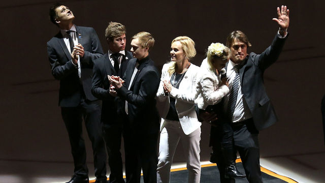ANAHEIM, CA - JANUARY 11: Former Anaheim Ducks star Teemu Selanne waves as he stands with wife Sirpa and sons Eemil, Eetu, and Leevi and holds daughter Veera after the raising of his banner during ceremonies retiring Selanne's number by the Ducks before the game with the Winnipeg Jets at Honda Center on January 11, 2015 in Anaheim, California.