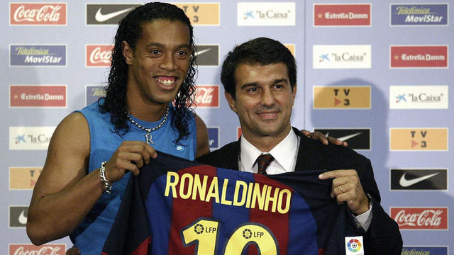 Barcelona's new Brazilian soccer star Ronaldinho (L) and Barcelona newly-elected president Joan Laporta (R) hold Ronaldinho 's jersey during his official presentation at the Nou Camp Stadium in Barcelona, 21 July 2003. AFP PHOTO JOSE JORDAN