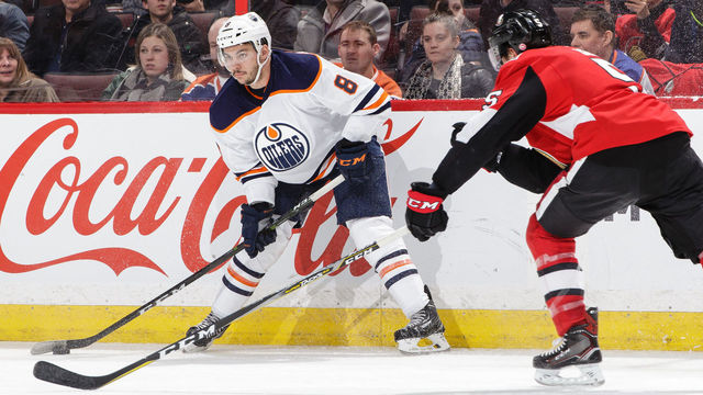 OTTAWA, ON - MARCH 22: Ty Rattie #8 of the Edmonton Oilers looks to make a pass against Cody Ceci #5 of the Ottawa Senators at Canadian Tire Centre on March 22, 2018 in Ottawa, Ontario, Canada.