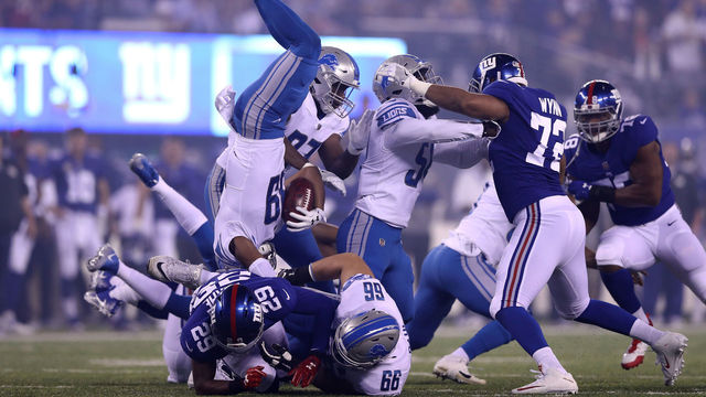 EAST RUTHERFORD, NJ - SEPTEMBER 18: Jamal Agnew #39 of the Detroit Lions gets twisted in the air after returning the opening kick off against the New York Giants during their game at MetLife Stadium on September 18, 2017 in East Rutherford, New Jersey.