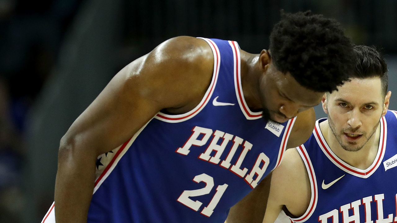 CHARLOTTE, NC - MARCH 06: Teammates Joel Embiid #21 and JJ Redick #17 of the Philadelphia 76ers talk against the Charlotte Hornets during their game at Spectrum Center on March 6, 2018 in Charlotte, North Carolina.