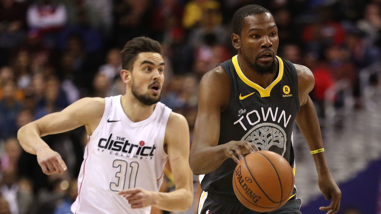 WASHINGTON, DC - FEBRUARY 28: Kevin Durant #35 of the Golden State Warriors dribbles past Tomas Satoransky #31 of the Washington Wizards during the first half at Capital One Arena on February 28, 2018 in Washington, DC.