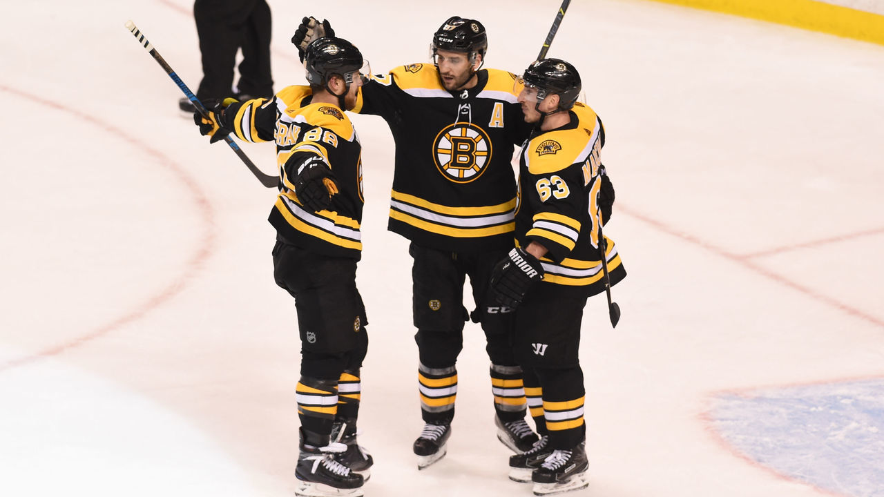 BOSTON, MA - MARCH 29: David Pastrnak #88, Patrice Bergeron #37 and Brad Marchand #63 of the Boston Bruins celebrate a goal against the Tampa Bay Lightning at the TD Garden on March 29, 2018 in Boston, Massachusetts.