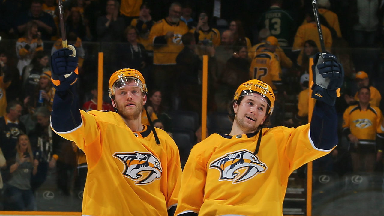 NASHVILLE, TN - MARCH 27: Mattias Ekholm #14 and Filip Forsberg #9 of the Nashville Predators celebrate after a 2-1 shootout win over the Minnesota Wild at Bridgestone Arena on March 27, 2018 in Nashville, Tennessee.