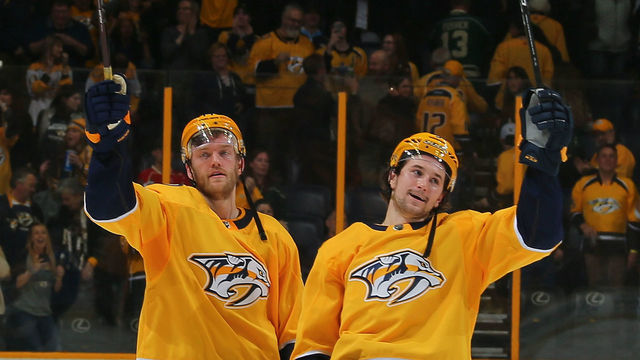 NASHVILLE, TN - MARCH 27: Mattias Ekholm #14 and Filip Forsberg #9 of the Nashville Predators celebrate after a 2-1 shootout win over the Minnesota Wild at Bridgestone Arena on March 27, 2018 in Nashville, Tennessee.