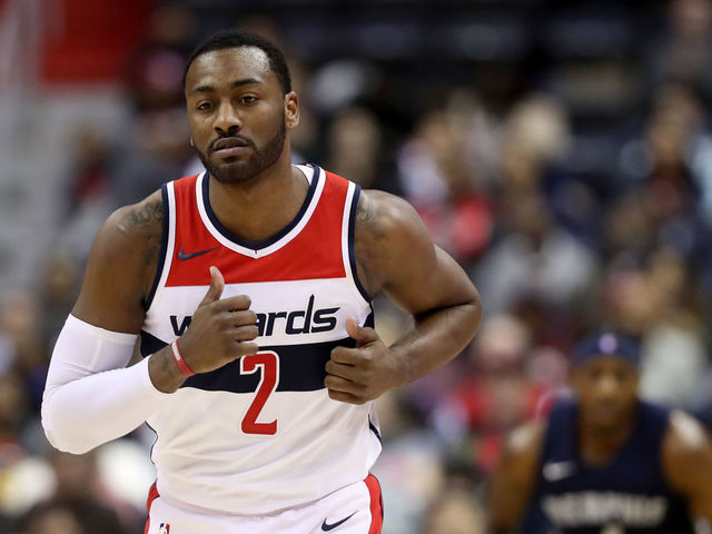 WASHINGTON, DC - DECEMBER 13: John Wall #2 of the Washington Wizards celebrates after hitting a three pointer against the Memphis Grizzlies at Capital One Arena on December 13, 2017 in Washington, DC.