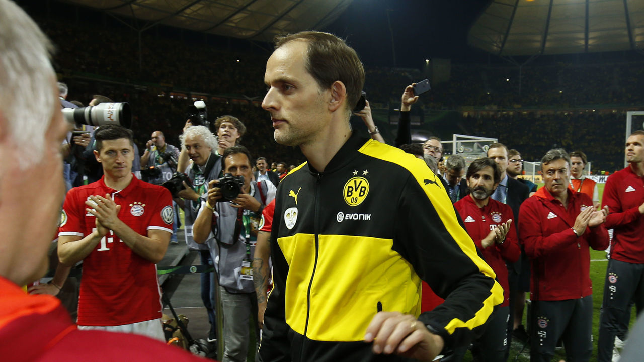 Dortmund's head coach Thomas Tuchel leaves the pitch after the German Cup (DFB Pokal) final football match Bayern Munich vs Borussia Dortmund at the Olympic stadium in Berlin on May 21, 2016. / AFP / ODD ANDERSEN / RESTRICTIONS: ACCORDING TO DFB RULES IMAGE SEQUENCES TO SIMULATE VIDEO IS NOT ALLOWED DURING MATCH TIME. MOBILE (MMS) USE IS NOT ALLOWED DURING AND FOR FURTHER TWO HOURS AFTER THE MATCH. == RESTRICTED TO EDITORIAL USE == FOR MORE INFORMATION CONTACT DFB DIRECTLY AT +49 69 67880 /